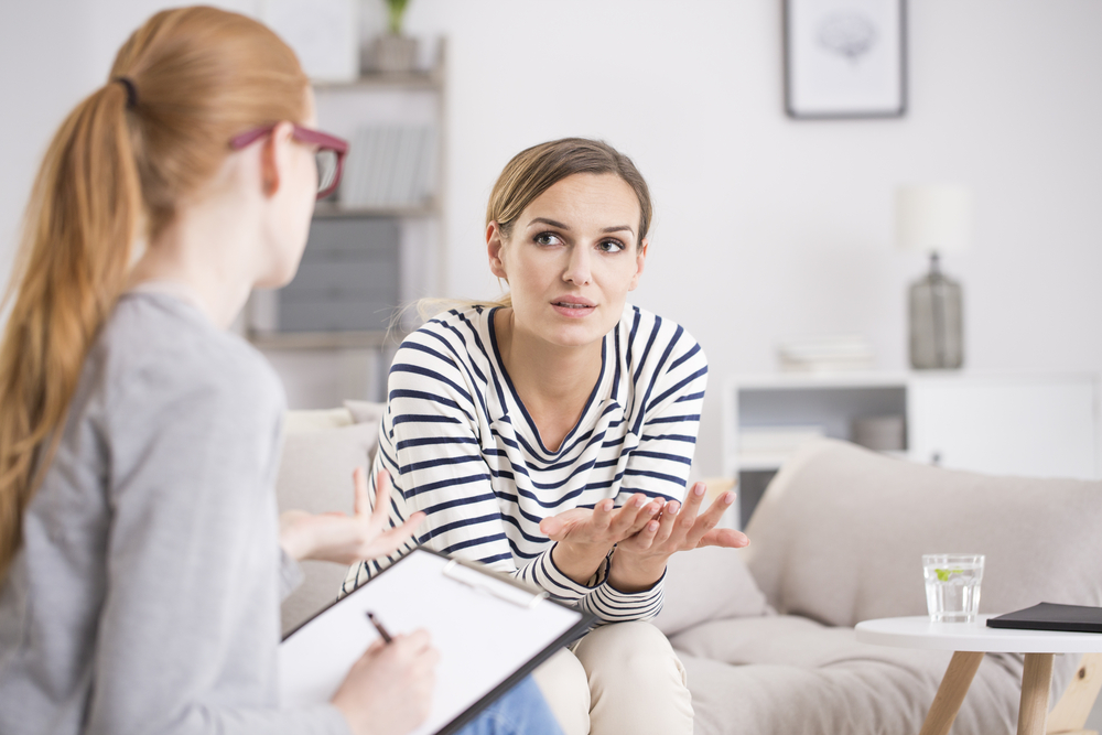 Woman talks to mental health professional